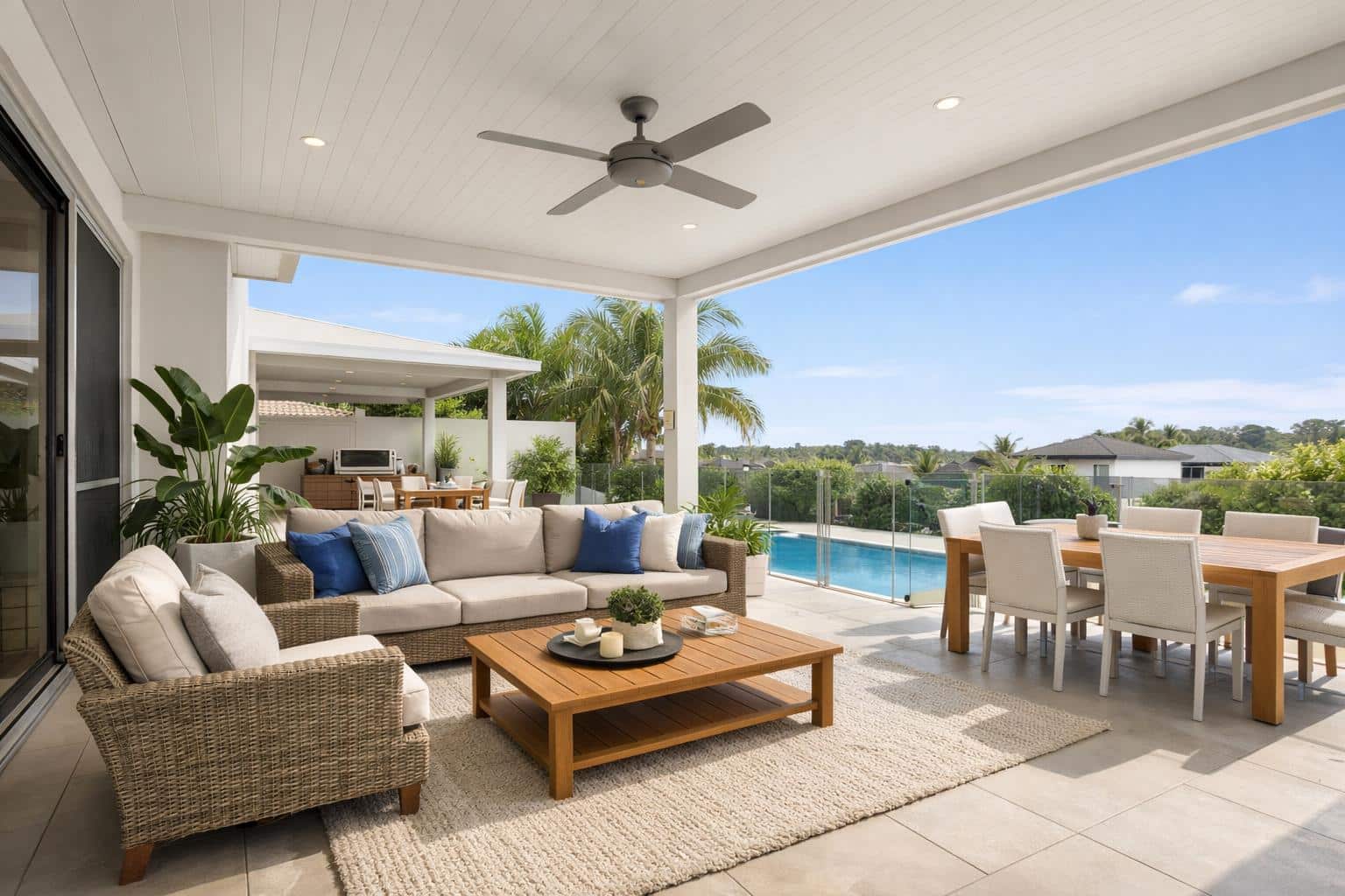 Modern outdoor patio with insulated roof providing shade and comfortable seating area in a coastal home