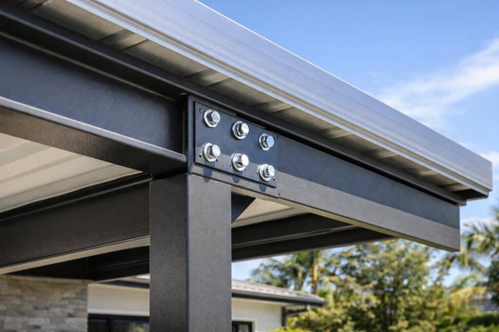 Detailed view of steel framing and roofing materials used in a durable carport structure.