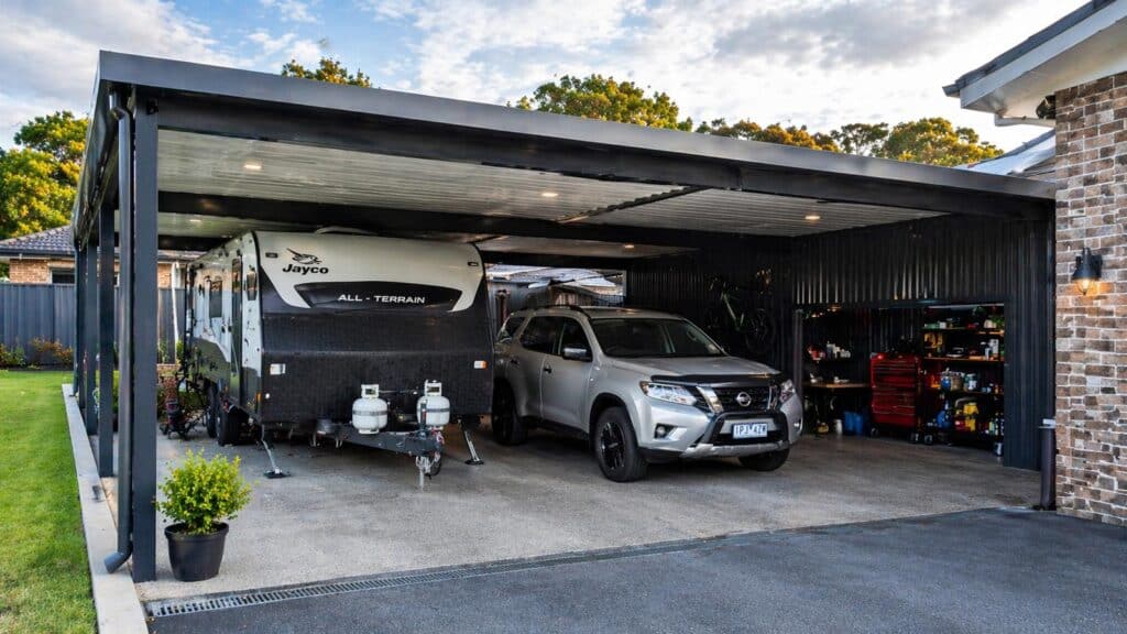 Spacious carport designed for multiple uses including vehicle protection, caravan storage, and household equipment.