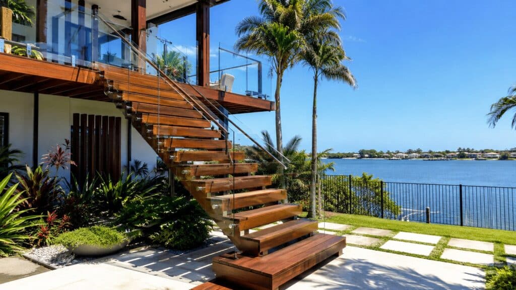 Custom hardwood staircase overlooking the Broadwater at a modern Hollywell waterfront home.
