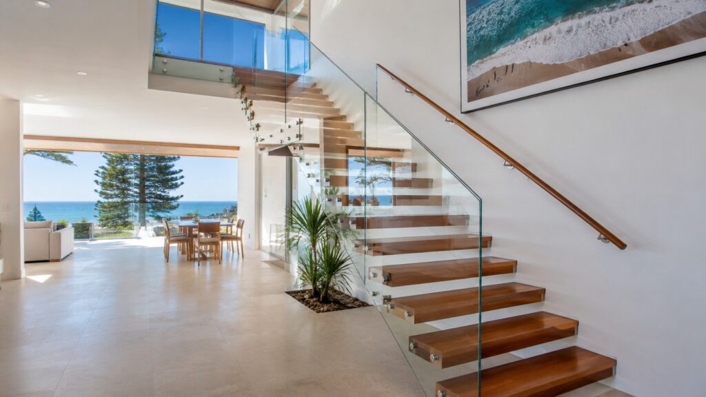 Modern Broadbeach home featuring a premium timber staircase with glass balustrades near the beach.
