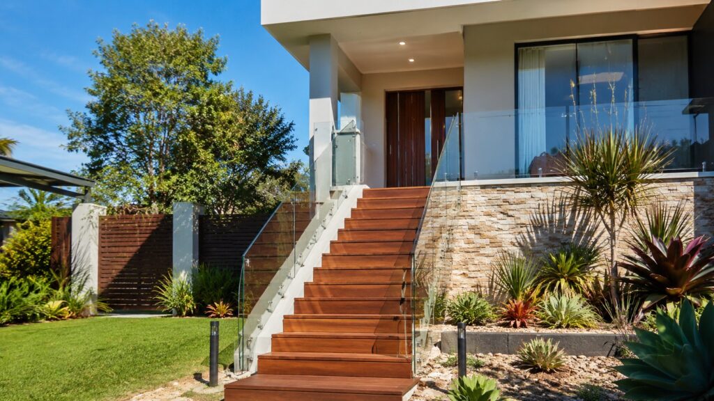 Modern Oxenford home featuring a custom hardwood staircase with frameless glass balustrade.