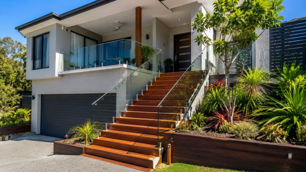 Modern Pacific Pines home featuring a custom hardwood outdoor staircase with glass balustrade.