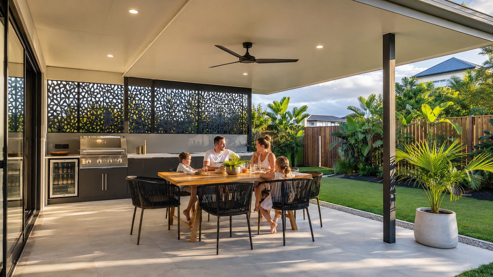 Modern Gold Coast patio with an insulated roof, ceiling fan, privacy screens, lighting and outdoor kitchen