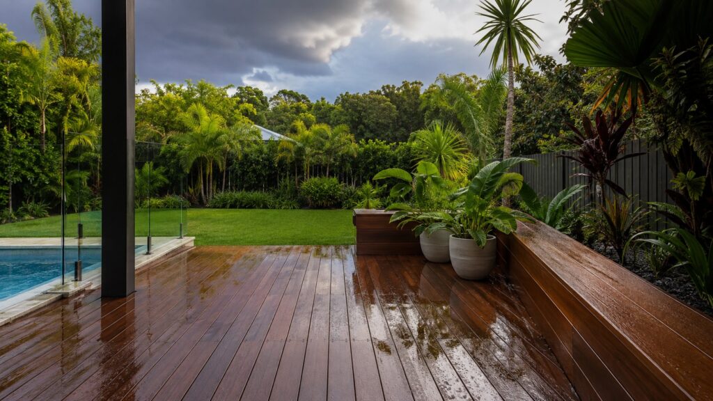 Wet timber deck and subtropical backyard after summer rain on the Gold Coast.