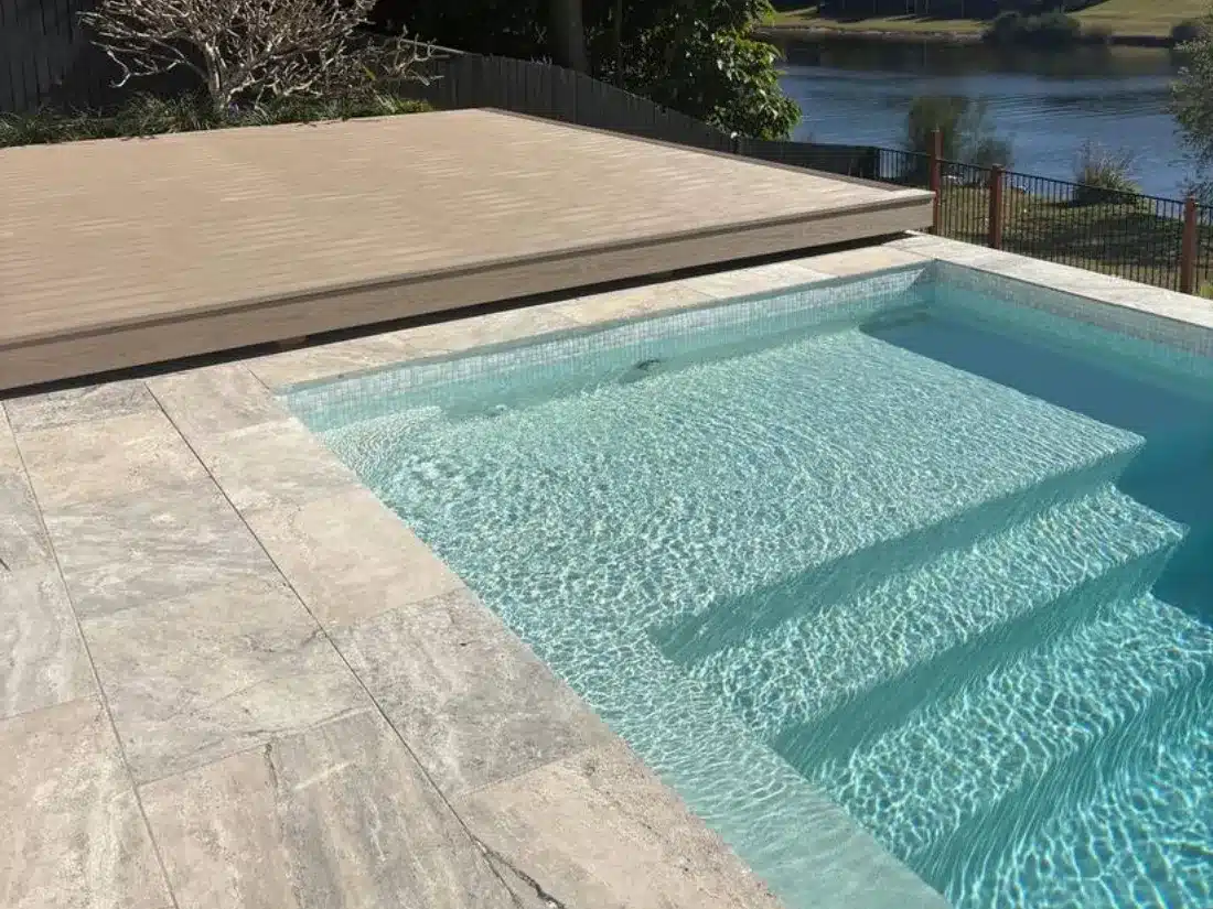 Poolside Composite Deck on the Waterfront 4 Low profile composite deck beside a paved pool on a waterfront block