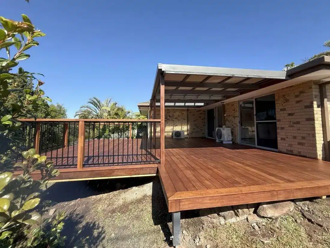 Wraparound Hardwood Deck on a Sloping Block 9 Wraparound hardwood deck with black aluminium balustrade raised on steel posts over a sloping block
